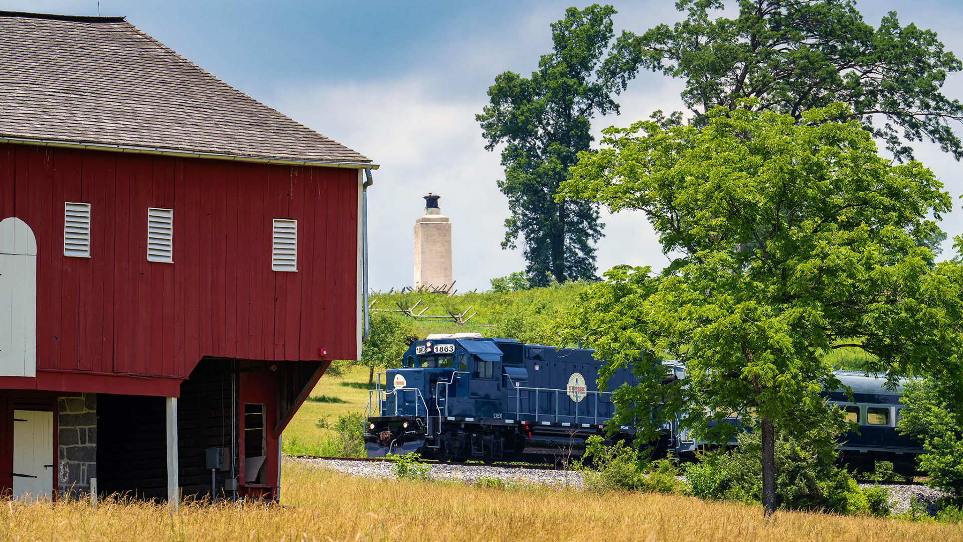 Blue train moving through the countryside near Gettysburg.