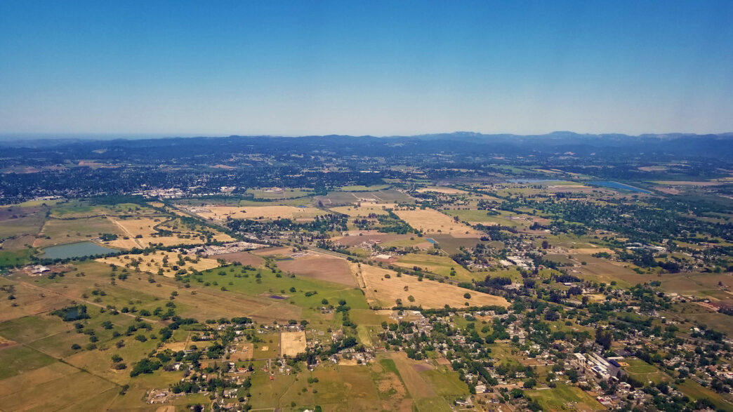 Green fields and farm land viewed from an airplane.