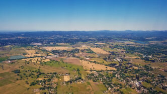Green fields and farm land viewed from an airplane.
