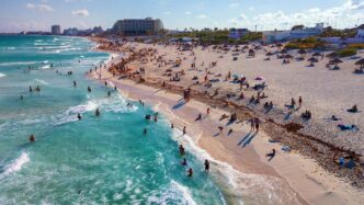 Crystal blue waters and sandy beach in Cancun, Mexico.