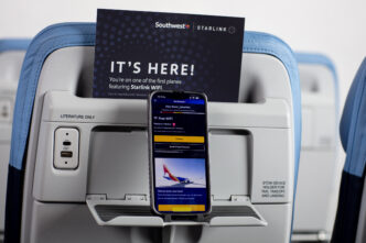 Mobile phone in the seat back on a aircraft showing it's connected to free wi-fi.