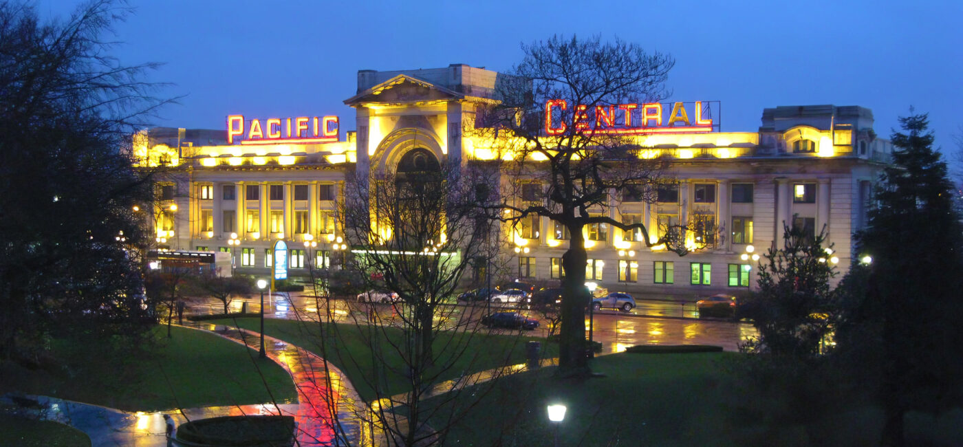 Pacific Central Station in Vancouver, BC on a rainy night with shiny sidewalks and streets.